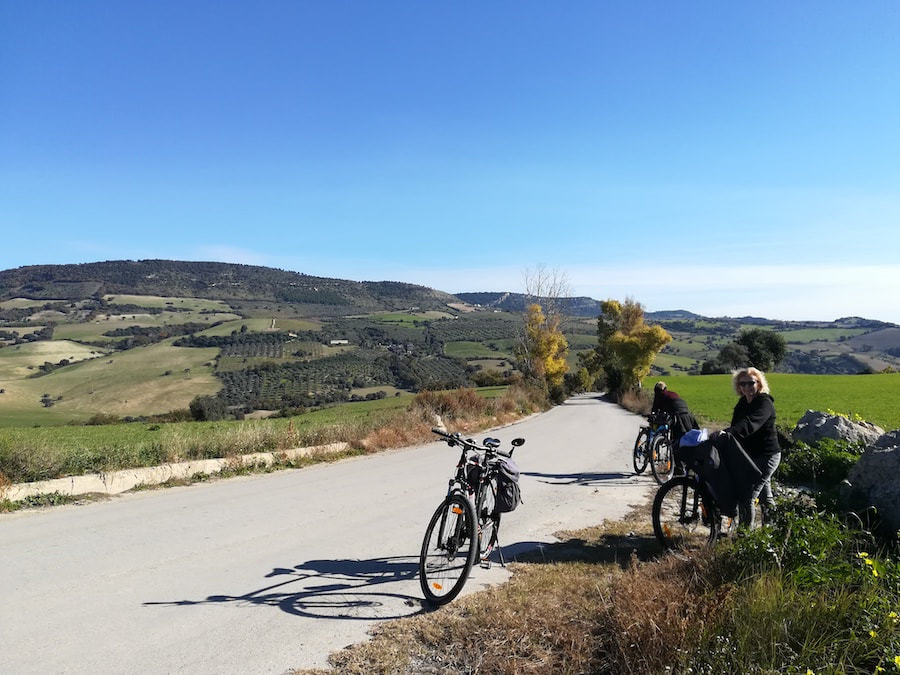 Cyclists resting on a quiet country road across the Iblei plateau near Ragusa
