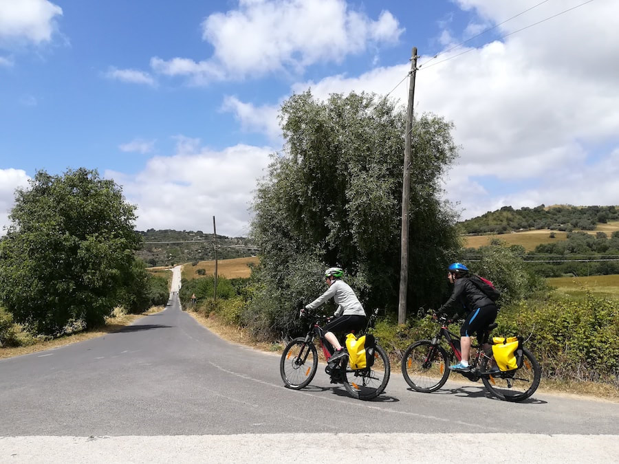 Piazza Armerina and its cathedral seen from a panoramic road, with a rental bike in the foreground